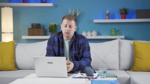 Home office worker man looking emotional at camera.