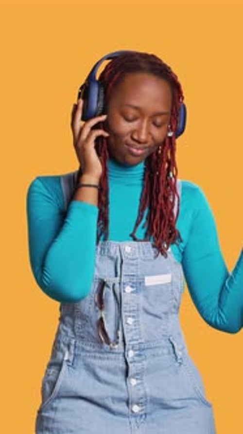 Vertical Video Joyful Girl Listening to Music Dancing
