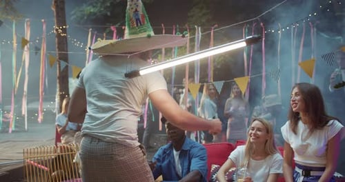 Friends Celebrate at an Outdoor Party, Clinking Drinks