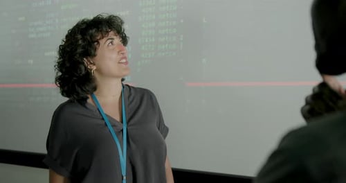 Female Young Adult Engineer Presenting in Office using Projection Screen
