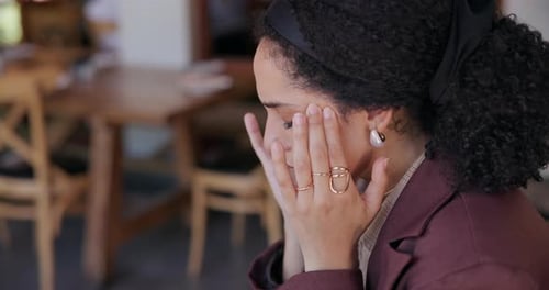 Business, headache and woman in cafe, pain and overwhelmed with bad news, stress and tired