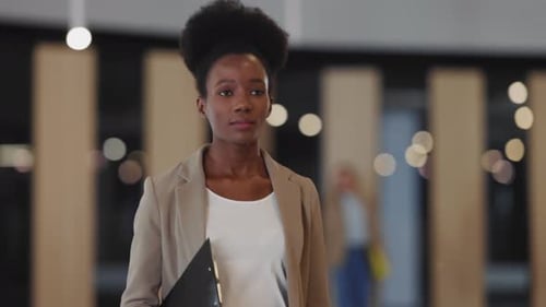 AfroAmerican Young Corporate Woman Walking Into Office Through Modern Corridor Business Person