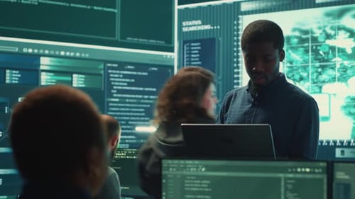 Tech Team Working on Computers in Modern Office