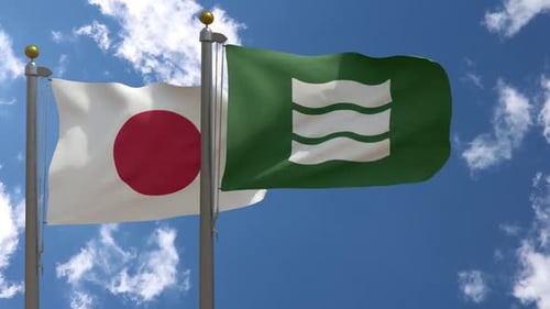 Japan National Flag and Green Waving Flag Against Blue Sky