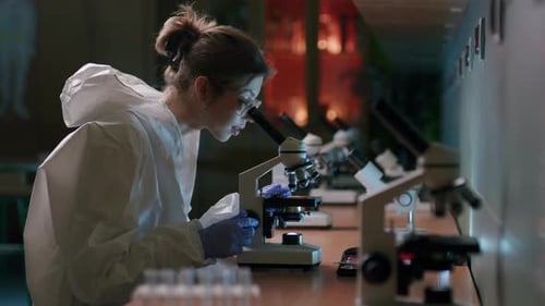 Woman Scientist Working With Microscope in Lab