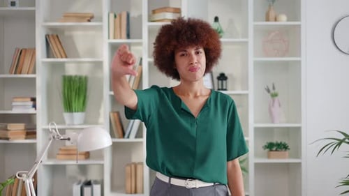 Businesswoman Gives Thumbs Down in Office Setting