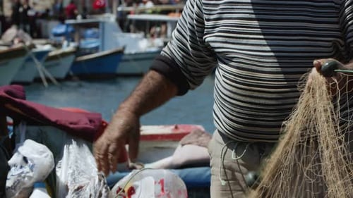 Fisherman Is Repairing Fishnets On Fishing Boat In Dock 18