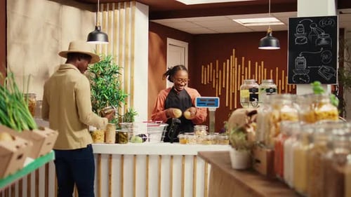 Local Vendor Weighting Fresh Produce for Customer at Farmers Market