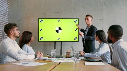 Business Team Meeting Discussing Strategies in a Modern Office Space