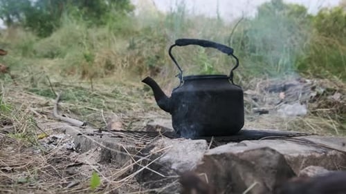 Old Kettle Standing on a Tourist Campfire in Nature