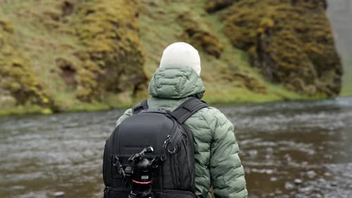 Man With Backpack Hiking By River