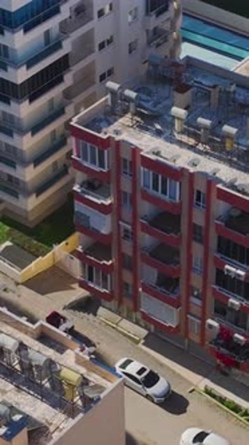 Vertical Video of Rooftops in a Mountain Town Captured From a Drone With Wooden Houses and