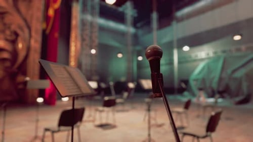 Close-up Microphone on Stage with Music Stands