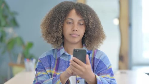 Woman Using Smartphone Indoors in Mid Shot