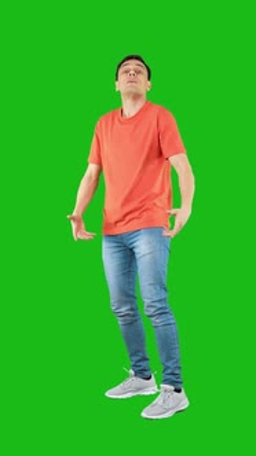 Aggressive Man Punching Camera with Fist Green Background