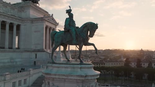 Aerial view close to the Equestrian statue of Vittorio Emanuele II, sunset in Rome, Italy - orbit,
