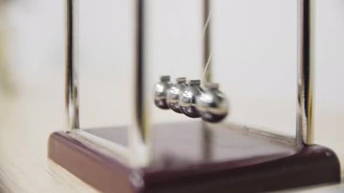 Swinging Newton's Cradle Illustrates Physics Principles