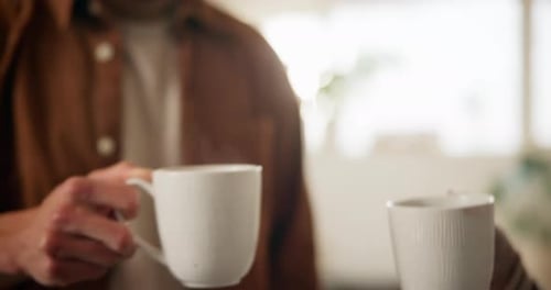 People Toasting Coffee Mugs Inside During Daytime