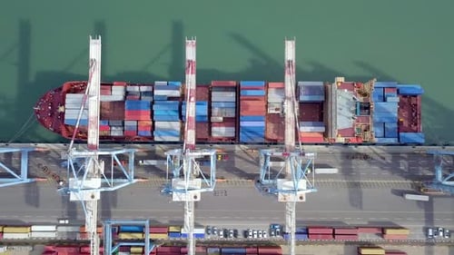 Port work - Aerial footage of Three cranes Loading and unloading a containers