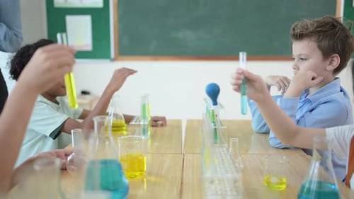 Teacher and students, Learn and experiment with science in a school science classroom.