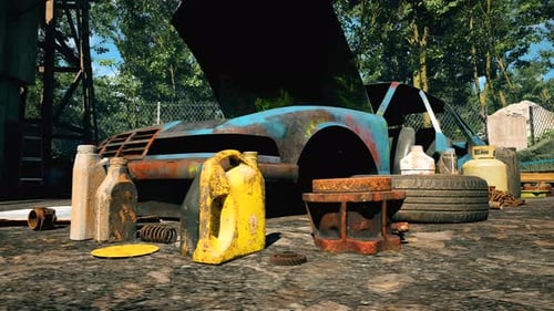 An old car and auto parts are scattered in a sunny forest-side repair yard.
