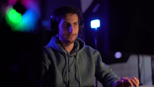 Young Man Playing Computer Game at Night