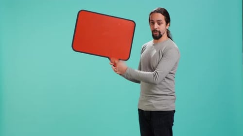 Young Adult Holding Orange Cartoon Speech Bubble