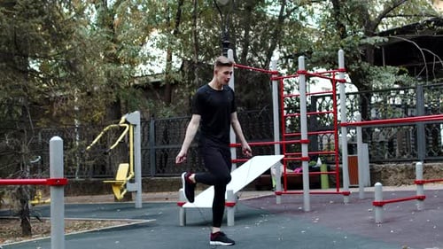 Young Caucasian Athlete in Sportswear Starting to Jump Rope at the Outdoor Workout Area