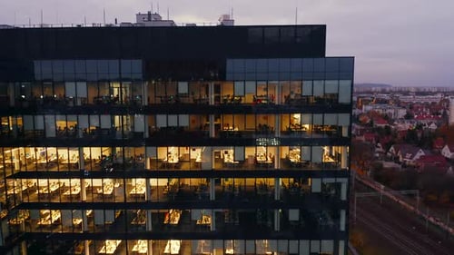 Cinematic Drone Shot of a Glass Facade of an Office Building Night
