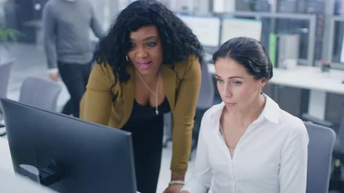 In Bright Modern Office: Beautiful Businesswoman Sitting and Working at Her Desktop Computer with F
