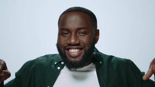 Portrait African American Man Making Funny Faces Expression in Light Background. Closeup