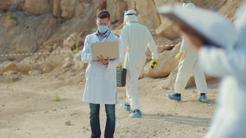 Scientists Working at an Outdoor Rocky Environment