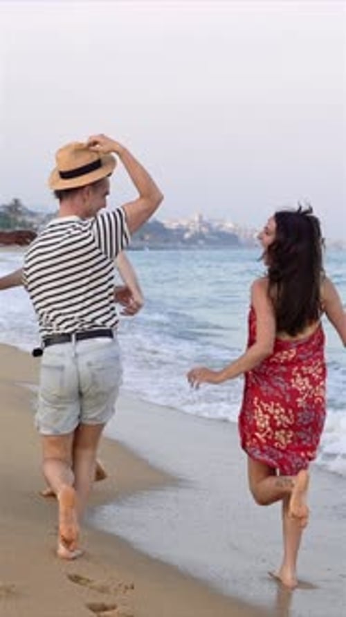 Young Friends Having Fun Running on the Beach Near the Sea at Sunset Lifestyle Travel Holiday