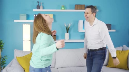 Happy Man and Woman Dancing at Home
