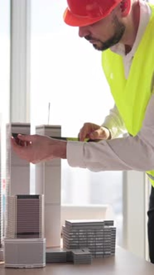 Architect Measuring Building Models