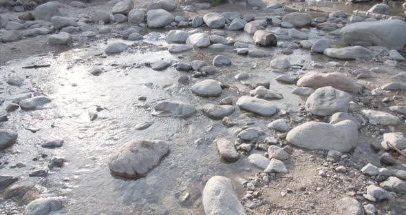 a California shallow stream running through sunken rocks, inside the ...