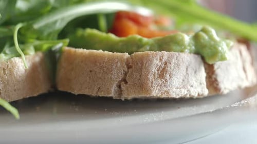 Fresh Avocado Toast Topped with Greens in a Cozy Cafe Setting