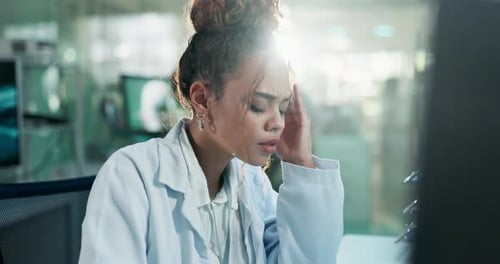 Young Woman Experiencing Headache in Science Lab