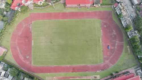 Football pitch seen from above on a neighborhood of Guwahati city in India, top down view