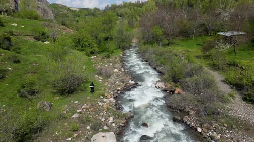 Male Walking In Nature At Waterfall