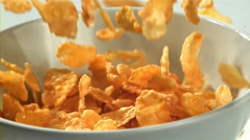 Golden Corn Flakes Cascading into a Bowl