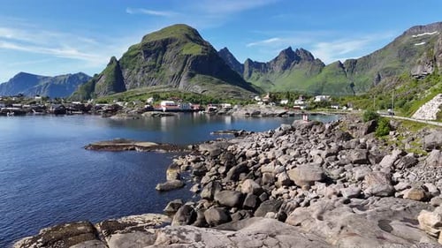 Aerial footage of the fishing village Å, nestled between steep mountains with scenic coastlines in