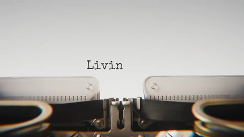Old mechanical typewriter typing Living With Purpose in a close-up view.