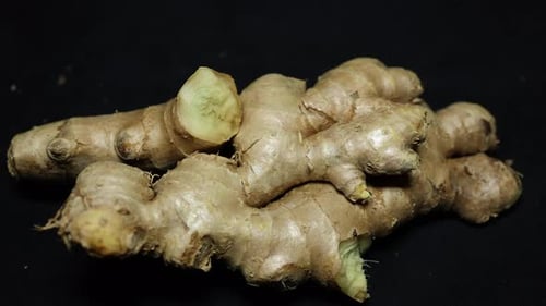fresh raw ginger close-up studio shot on black background