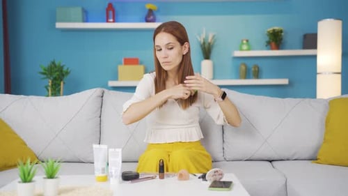 Young woman combing her hair. Hair care.