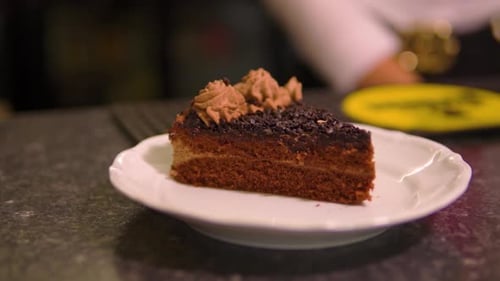 amazing push in shot of a freshly served chocolate cake in restaurant in slow motion
