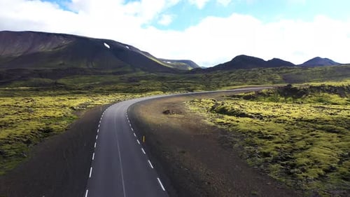 Aerial view of a road crossing a valley with mountain in Iceland.