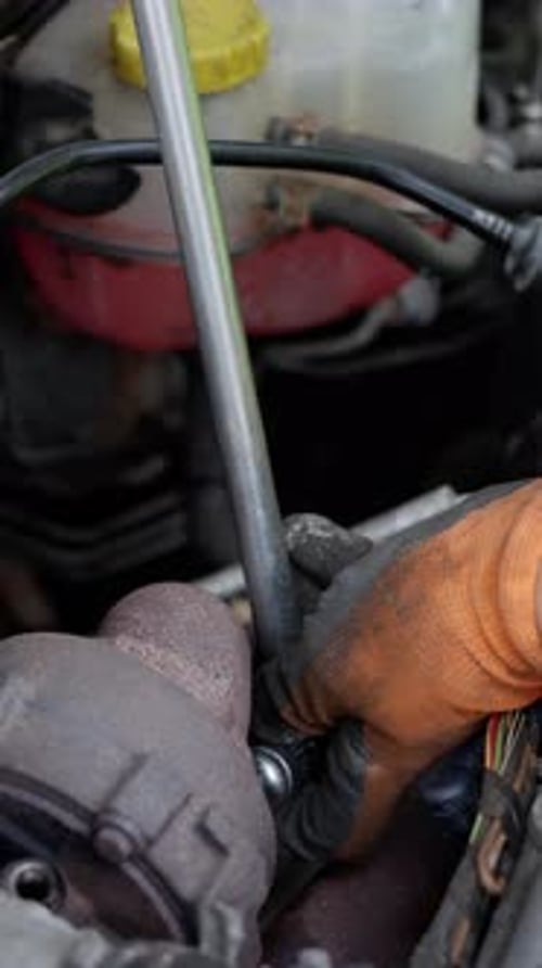 A Technician Skillfully Repairing an Engine with a Wrench Demonstrating Exceptional Automotive