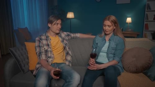 Couple Talking and Drinking Wine at Home