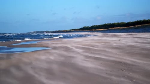 Sand floating in the strong wind on the beach